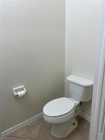 a white toilet sitting next to a shower