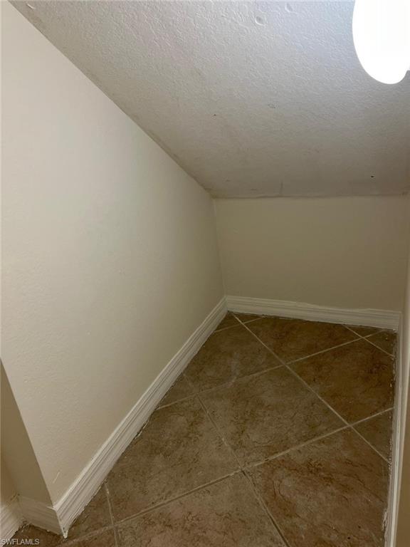 7515 Bristol Circle Naples, FL 34120 - Photo 24 of 42 an empty room with a bench