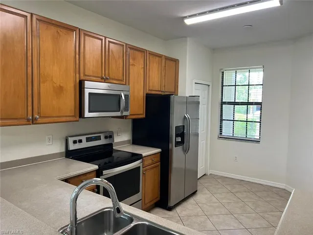 a view of a kitchen with a sink and cabinets