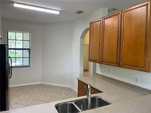 a kitchen with stainless steel appliances granite countertop a stove microwave and sink
