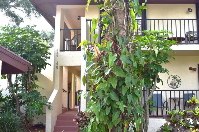 a view of a house with a flower garden
