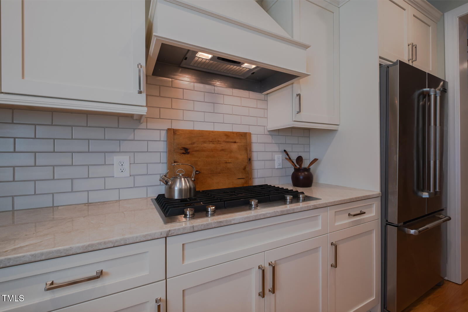 4331 Millcreek Circle Pittsboro, NC 27312 - Photo 11 of 56 a kitchen with a refrigerator and cabinets