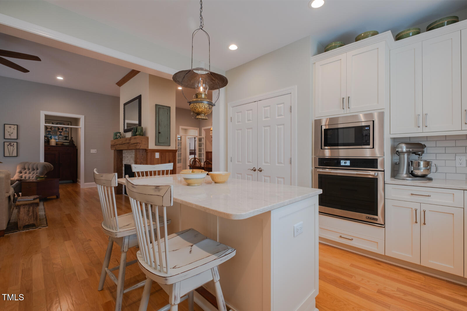 4331 Millcreek Circle Pittsboro, NC 27312 - Photo 12 of 56 a kitchen with a dining table cabinets appliances and wooden floor