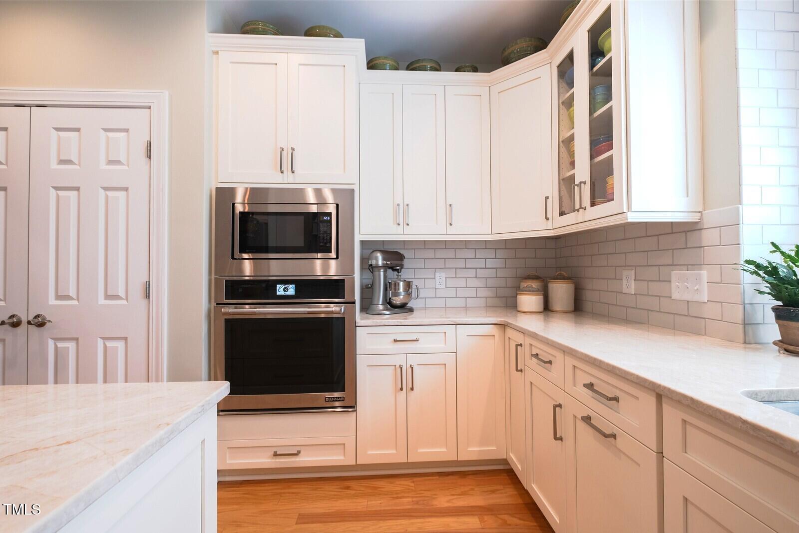 4331 Millcreek Circle Pittsboro, NC 27312 - Photo 13 of 56 a kitchen with granite countertop white cabinets and stainless steel appliances