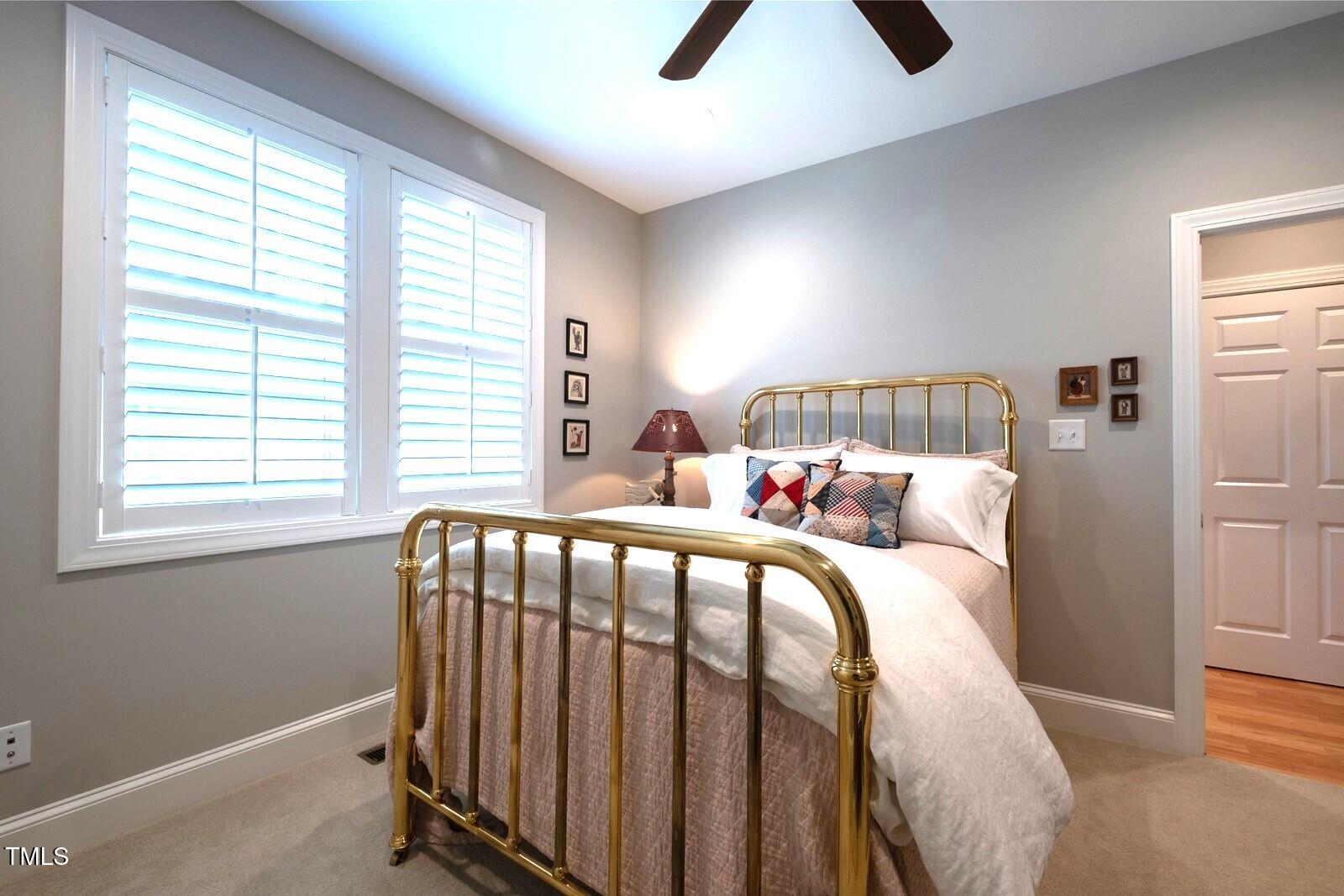 4331 Millcreek Circle Pittsboro, NC 27312 - Photo 40 of 56 a bed sitting in a bedroom next to a window