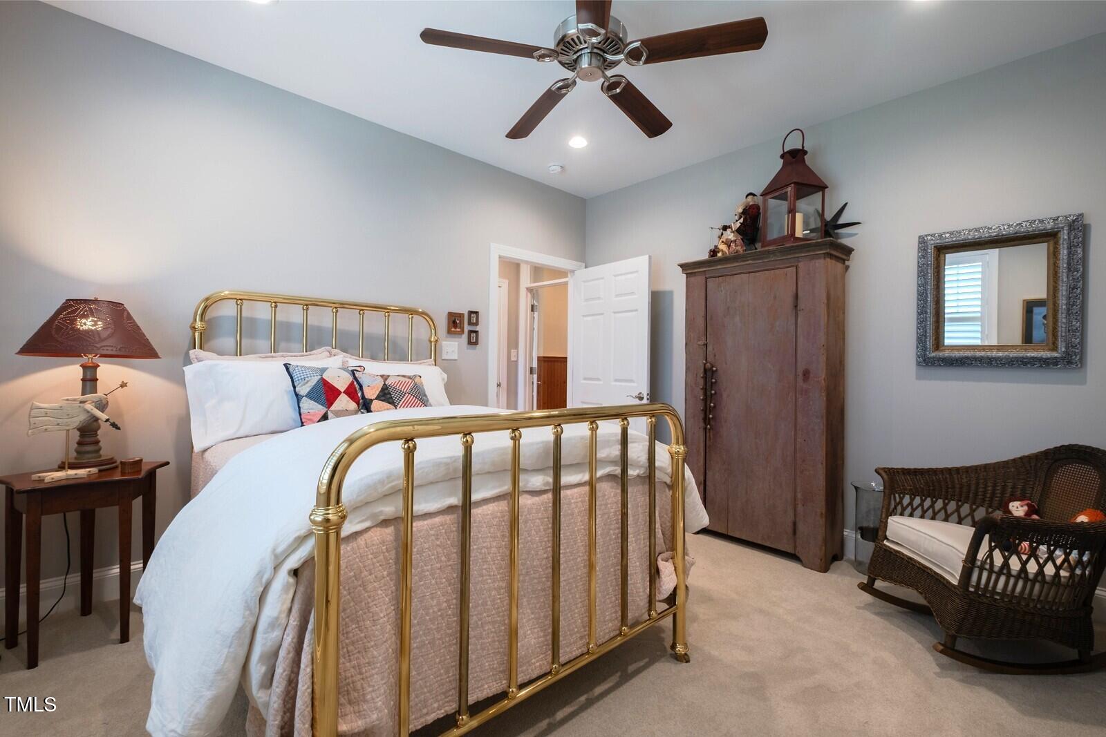 4331 Millcreek Circle Pittsboro, NC 27312 - Photo 42 of 56 a bedroom with a bed and a chandelier