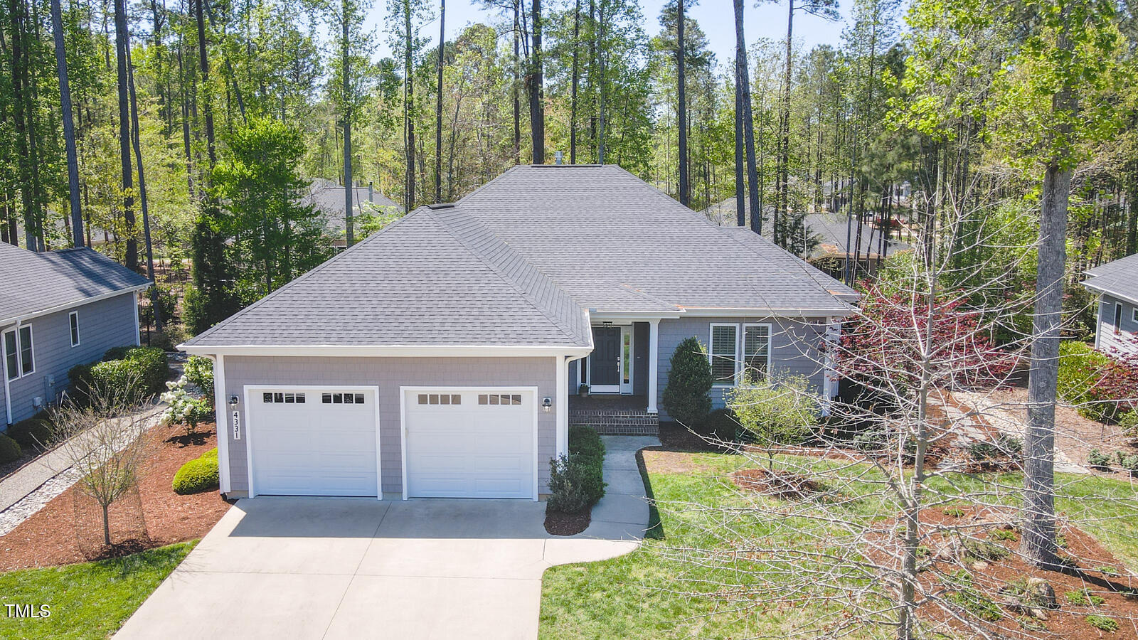 4331 Millcreek Circle Pittsboro, NC 27312 - Photo 48 of 56 a front view of a house with a yard and potted plants