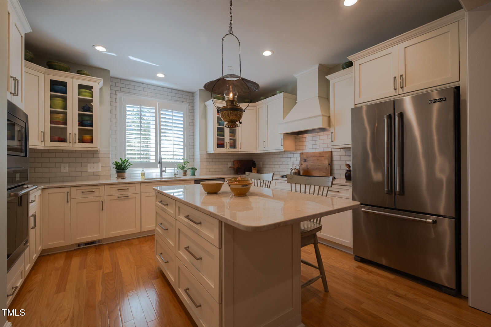 4331 Millcreek Circle Pittsboro, NC 27312 - Photo 9 of 56 a kitchen with refrigerator cabinets and wooden floor