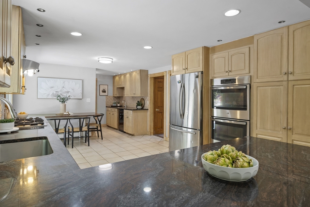 12 Colonial Lane Canton, MA 02021 - Photo 15 of 42 a kitchen with stainless steel appliances granite countertop a refrigerator and a stove top oven