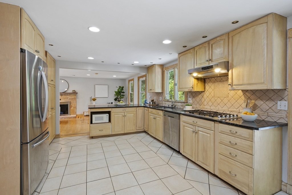 12 Colonial Lane Canton, MA 02021 - Photo 16 of 42 a kitchen with stainless steel appliances granite countertop a refrigerator sink and cabinets