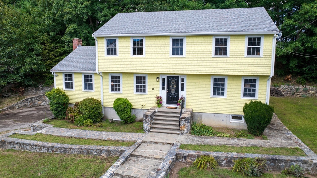 12 Colonial Lane Canton, MA 02021 - Photo 2 of 42 a front view of a house with garden