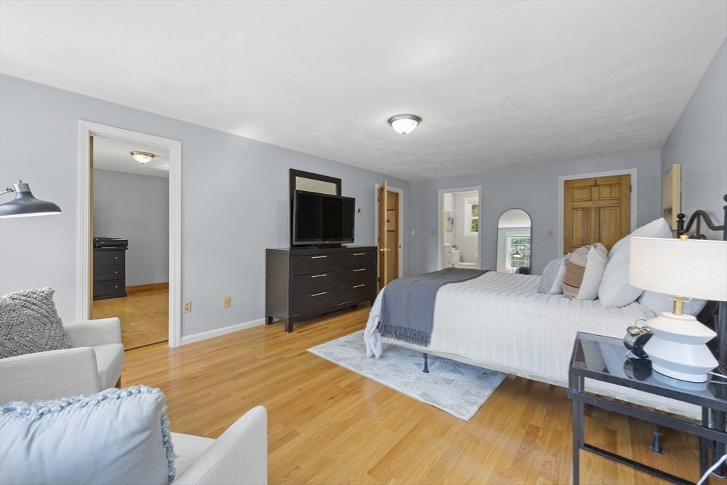 12 Colonial Lane Canton, MA 02021 - Photo 23 of 42 a bedroom with a bed and wooden floor