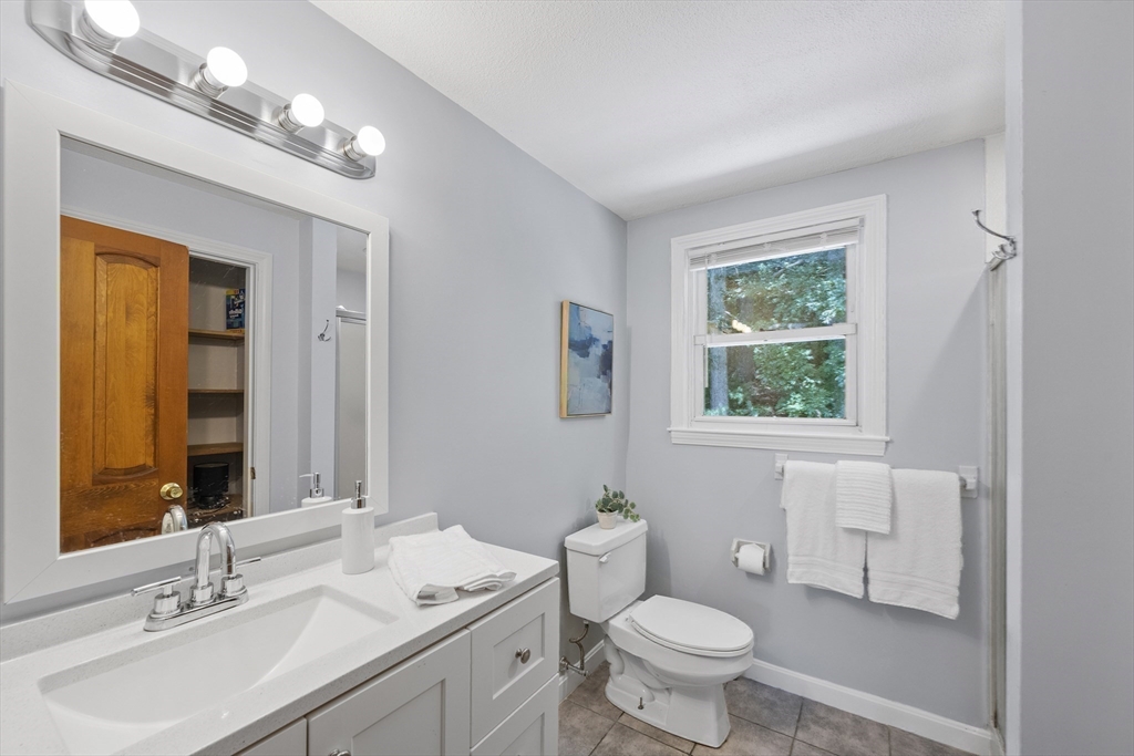 12 Colonial Lane Canton, MA 02021 - Photo 24 of 42 a bathroom with a toilet sink and mirror