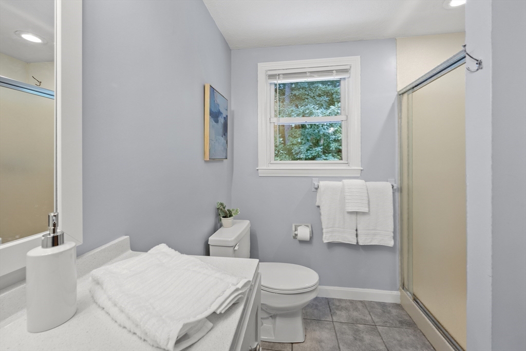 12 Colonial Lane Canton, MA 02021 - Photo 25 of 42 a white toilet sitting next to a bathroom sink