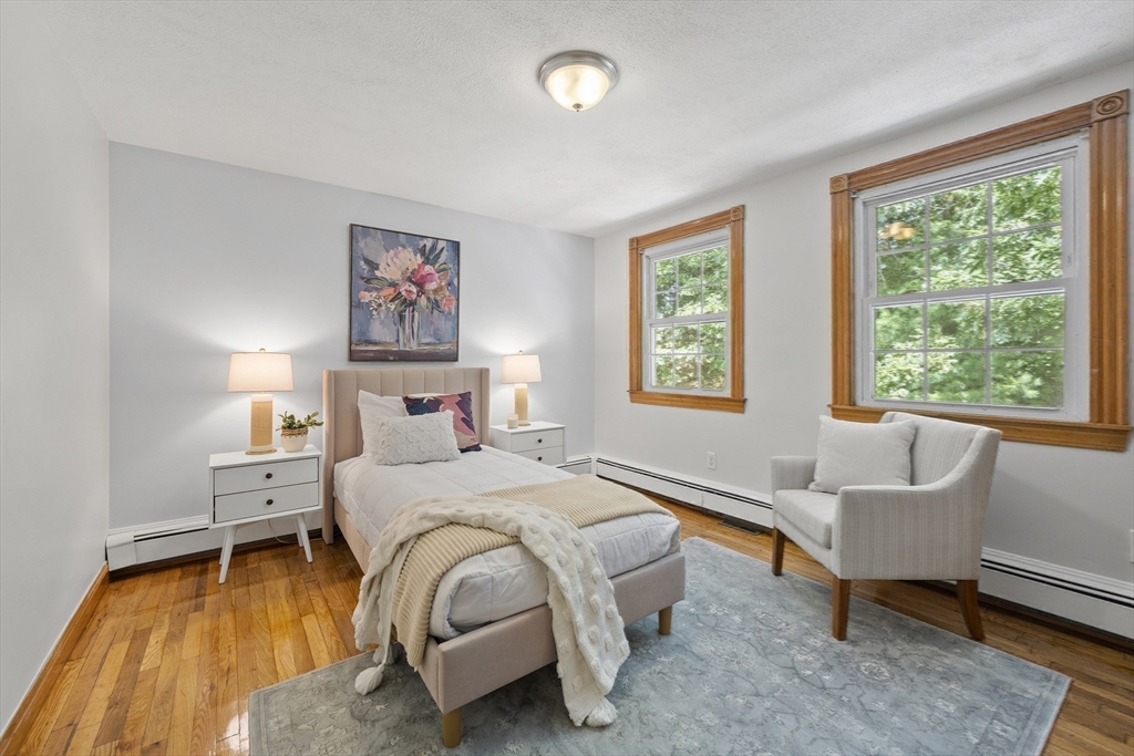 12 Colonial Lane Canton, MA 02021 - Photo 26 of 42 a spacious bedroom with a bed and a couch