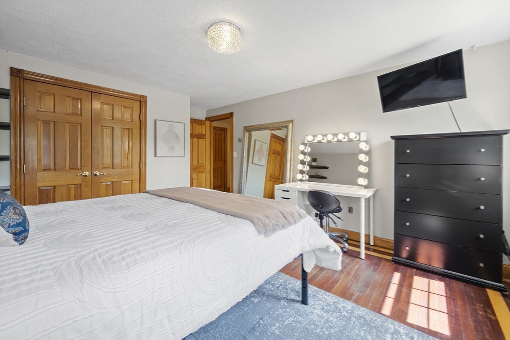 12 Colonial Lane Canton, MA 02021 - Photo 29 of 42 a bedroom with a bed and a flat screen tv