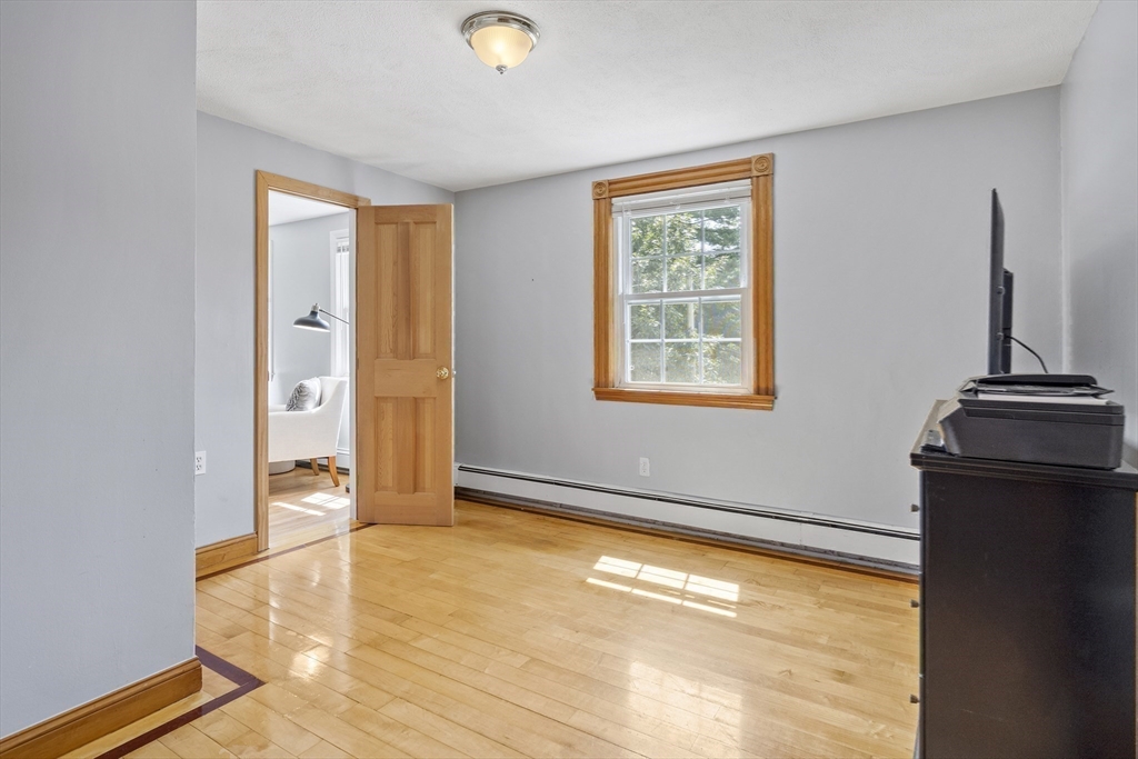 12 Colonial Lane Canton, MA 02021 - Photo 31 of 42 a view of an empty room with wooden floor and a window