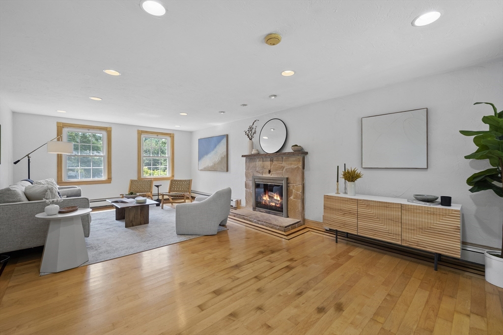 12 Colonial Lane Canton, MA 02021 - Photo 7 of 42 a living room with furniture a fireplace and a large window