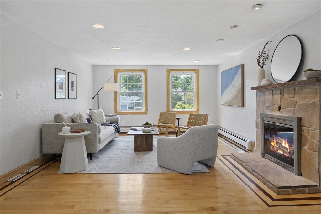 12 Colonial Lane Canton, MA 02021 - Photo 8 of 42 a living room with furniture a fireplace and a large window