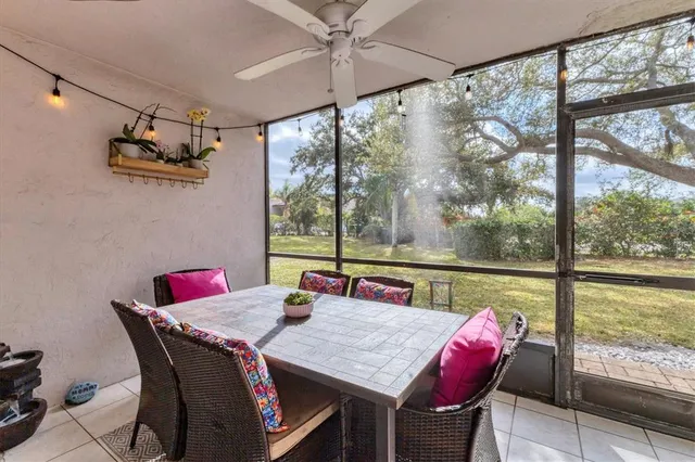 a front view of a dining room with furniture large windows and wooden floor