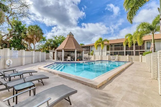 a view of a house with backyard and sitting area