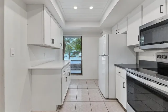 a kitchen with stainless steel appliances a refrigerator sink and microwave
