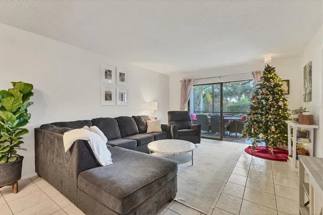 a living room with furniture and a floor to ceiling window