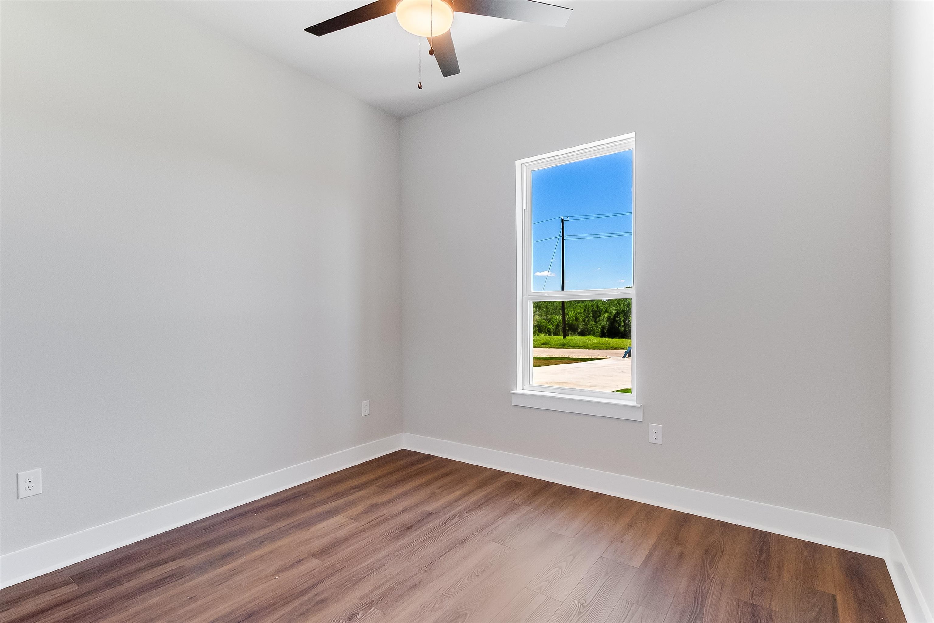 118 Rosebud Rnch Road Bertram, TX 78605 - Photo 12 of 23 an empty room with a window and wooden floor