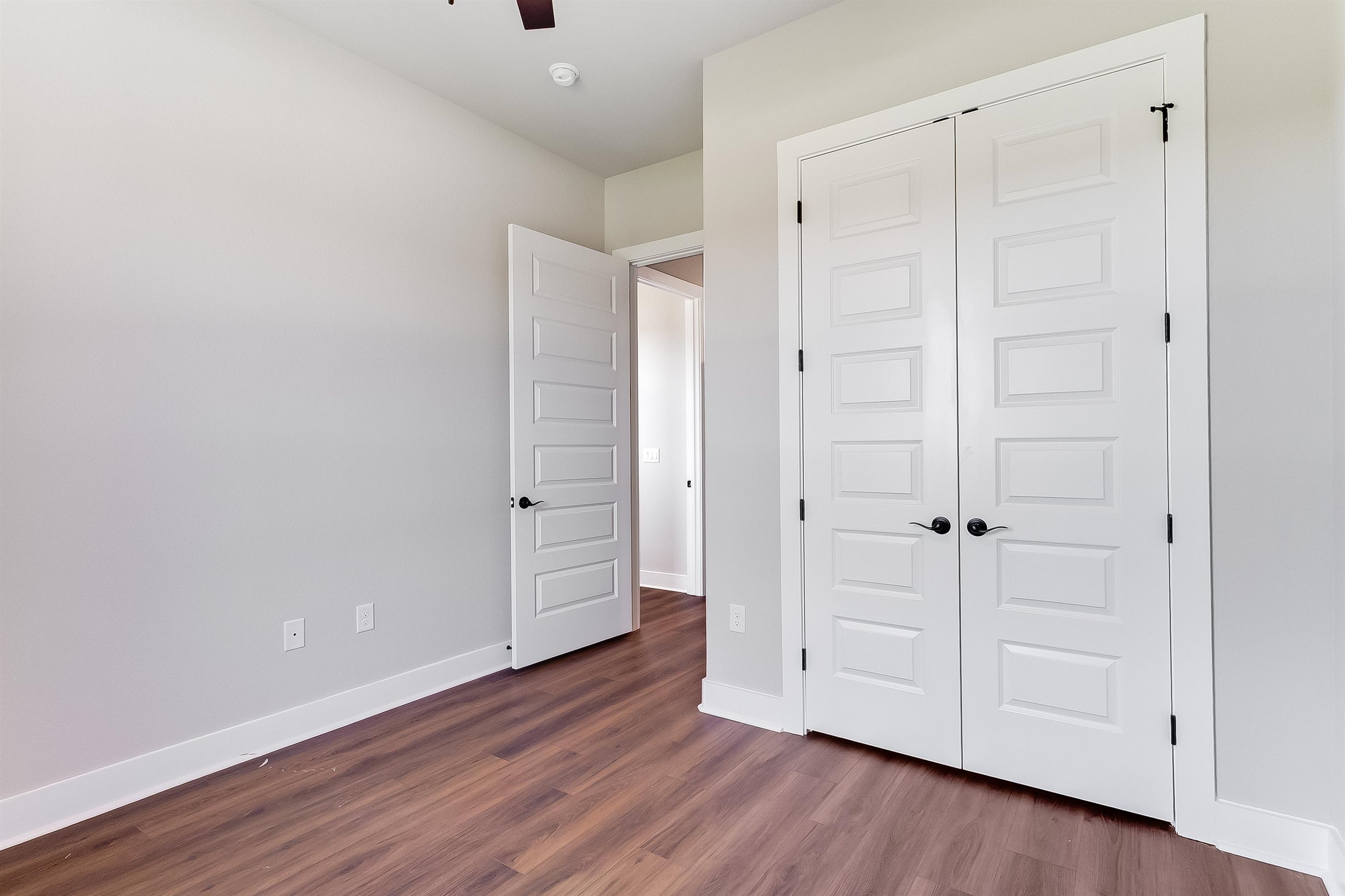 118 Rosebud Rnch Road Bertram, TX 78605 - Photo 13 of 23 a view of an empty room with wooden floor