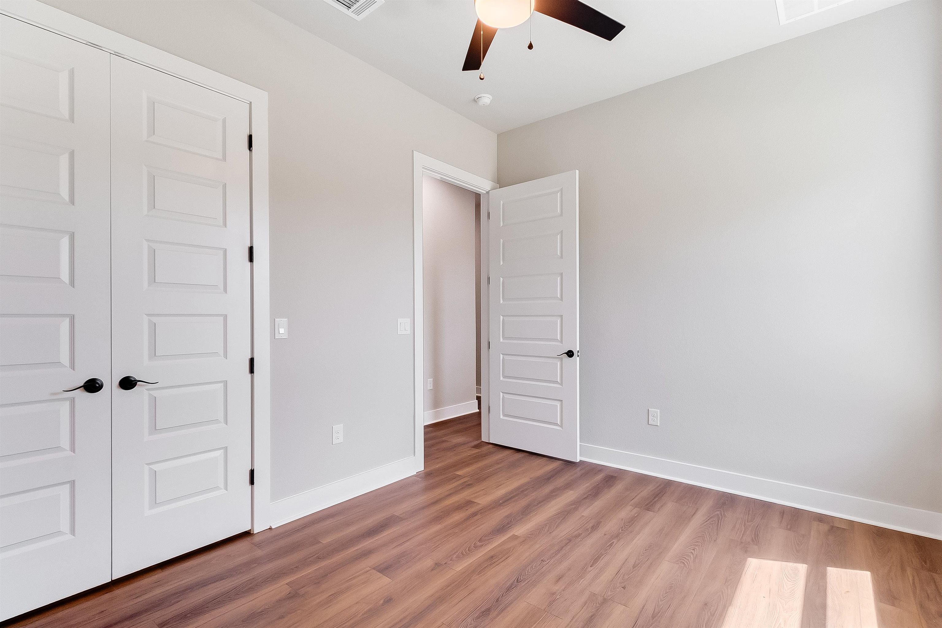 118 Rosebud Rnch Road Bertram, TX 78605 - Photo 14 of 23 an empty room with wooden floor cabinet and windows