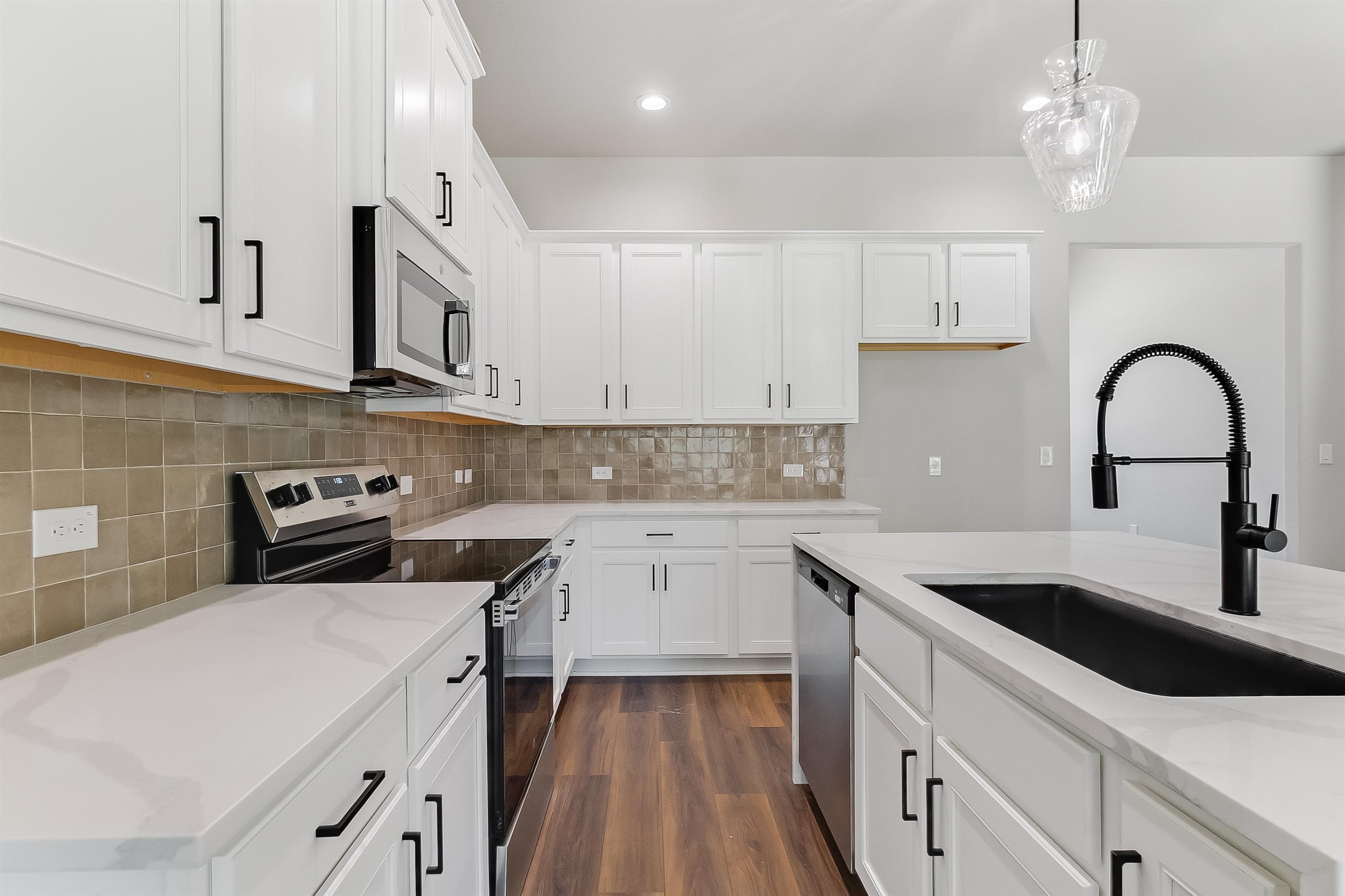 118 Rosebud Rnch Road Bertram, TX 78605 - Photo 4 of 23 a kitchen with stainless steel appliances granite countertop a sink a stove and cabinets