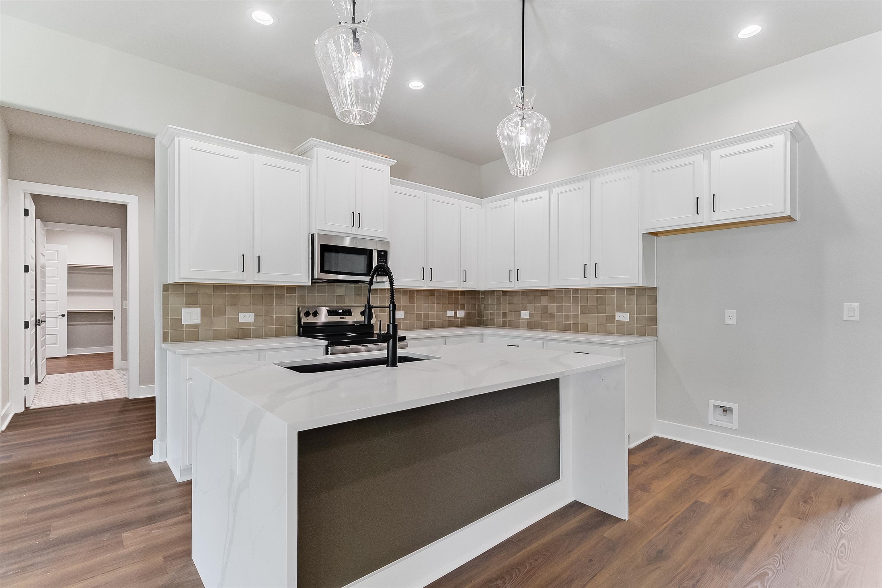 118 Rosebud Rnch Road Bertram, TX 78605 - Photo 5 of 23 a kitchen with a sink stainless steel appliances and wooden floor