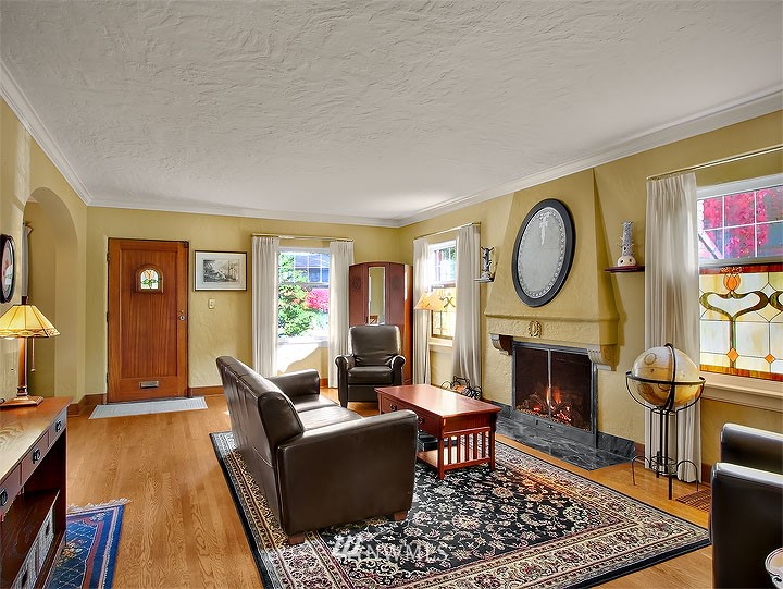 3015 West Viewmont Way West Seattle, WA 98199 - Photo 2 of 15 a living room with furniture a rug a fireplace and a window