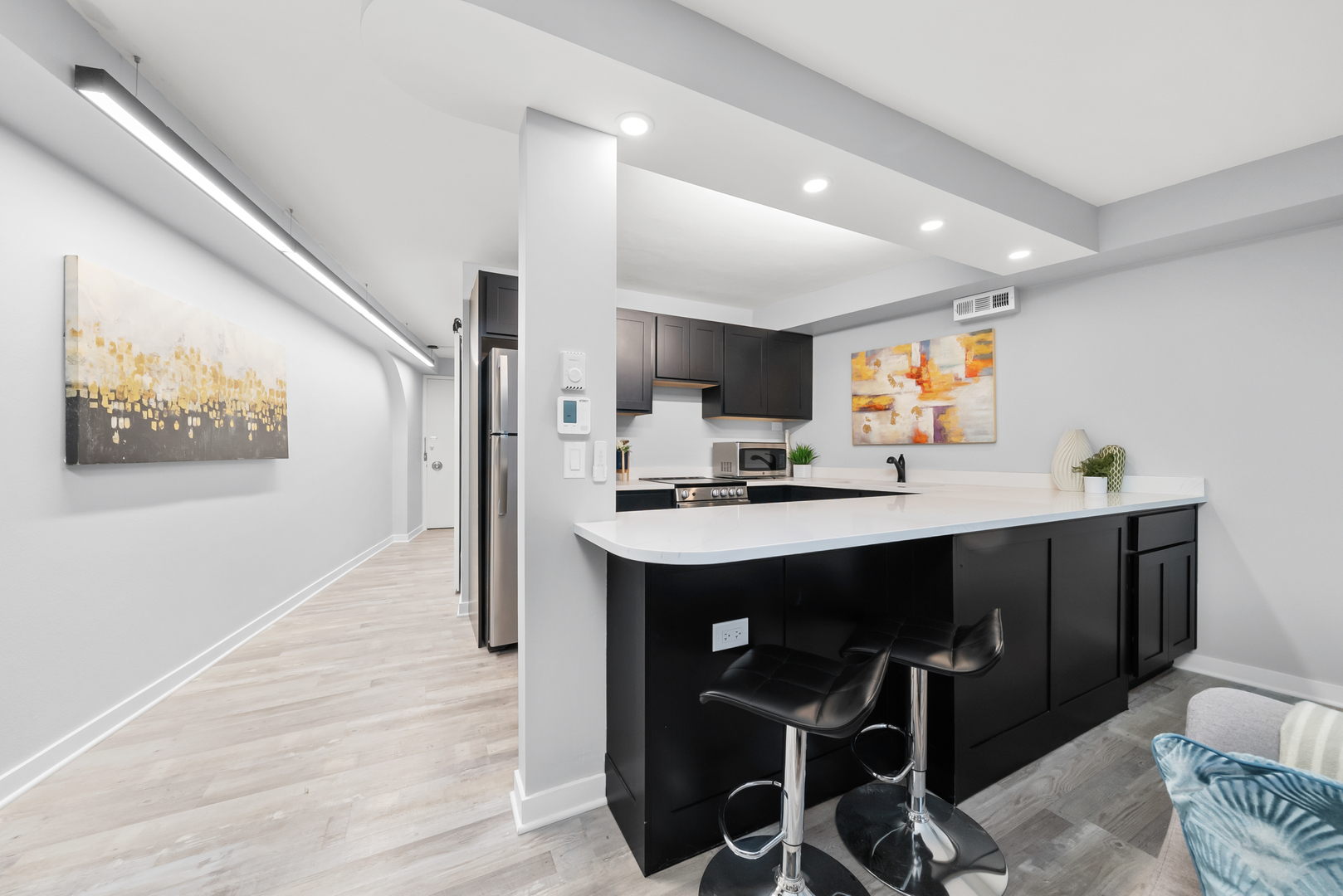 300 North State Street, Unit 5225 Chicago, IL 60654 - Photo 4 of 17 a kitchen with kitchen island stainless steel appliances a sink and counter space