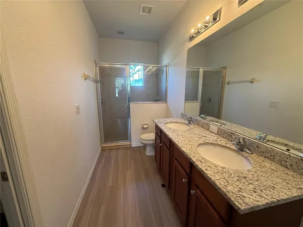 a bathroom with a granite countertop sink a vanity and a mirror