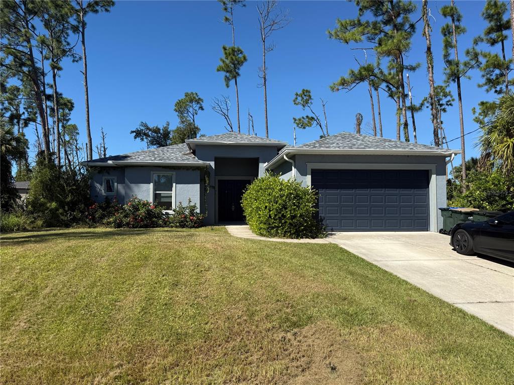 2143 Nabble Lane North Port, FL 34288 - Photo 2 of 17 a front view of a house with garden