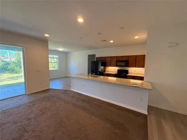 a view of kitchen and center island with large window