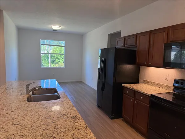 a kitchen with a refrigerator and a stove