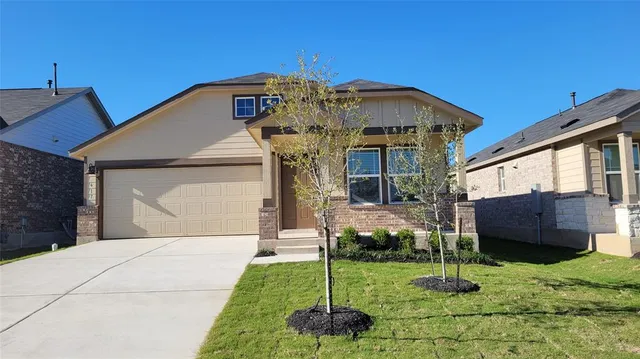 a front view of a house with a yard and porch