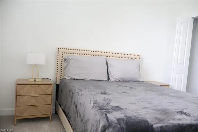 a bedroom with a bed and a lamp on table