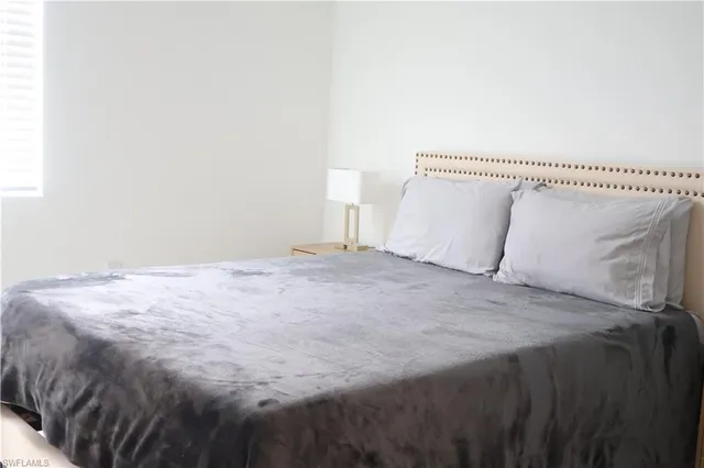 a bed room with a bed and a night stand