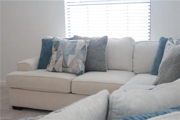a living room with couches and a large window
