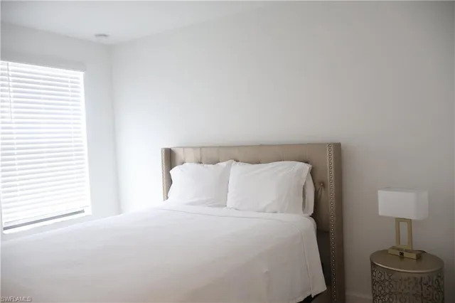 a bedroom with a bed and a lamp