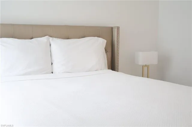 a bedroom with a bed and a night lamp