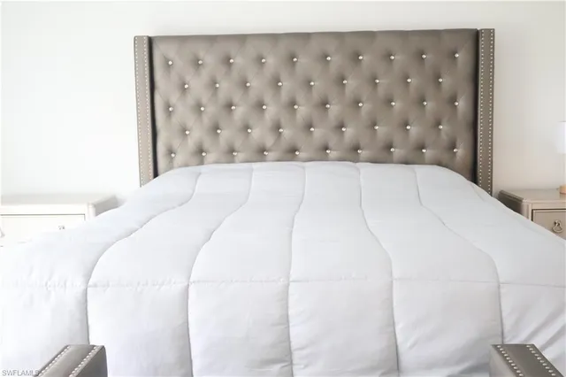 a close up of a white bed