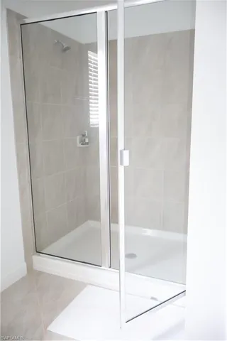 a bathroom with a glass shower door