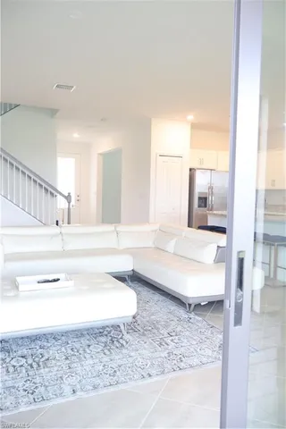 a view of a living room with furniture and a rug