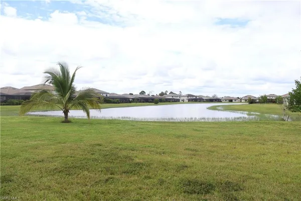 a view of a lake with houses in the background