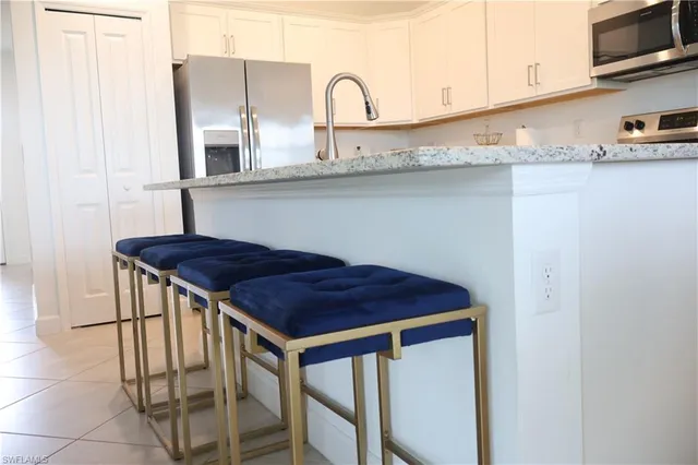 a kitchen with stainless steel appliances a sink and cabinets