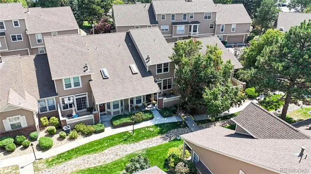 an aerial view of multiple houses with yard